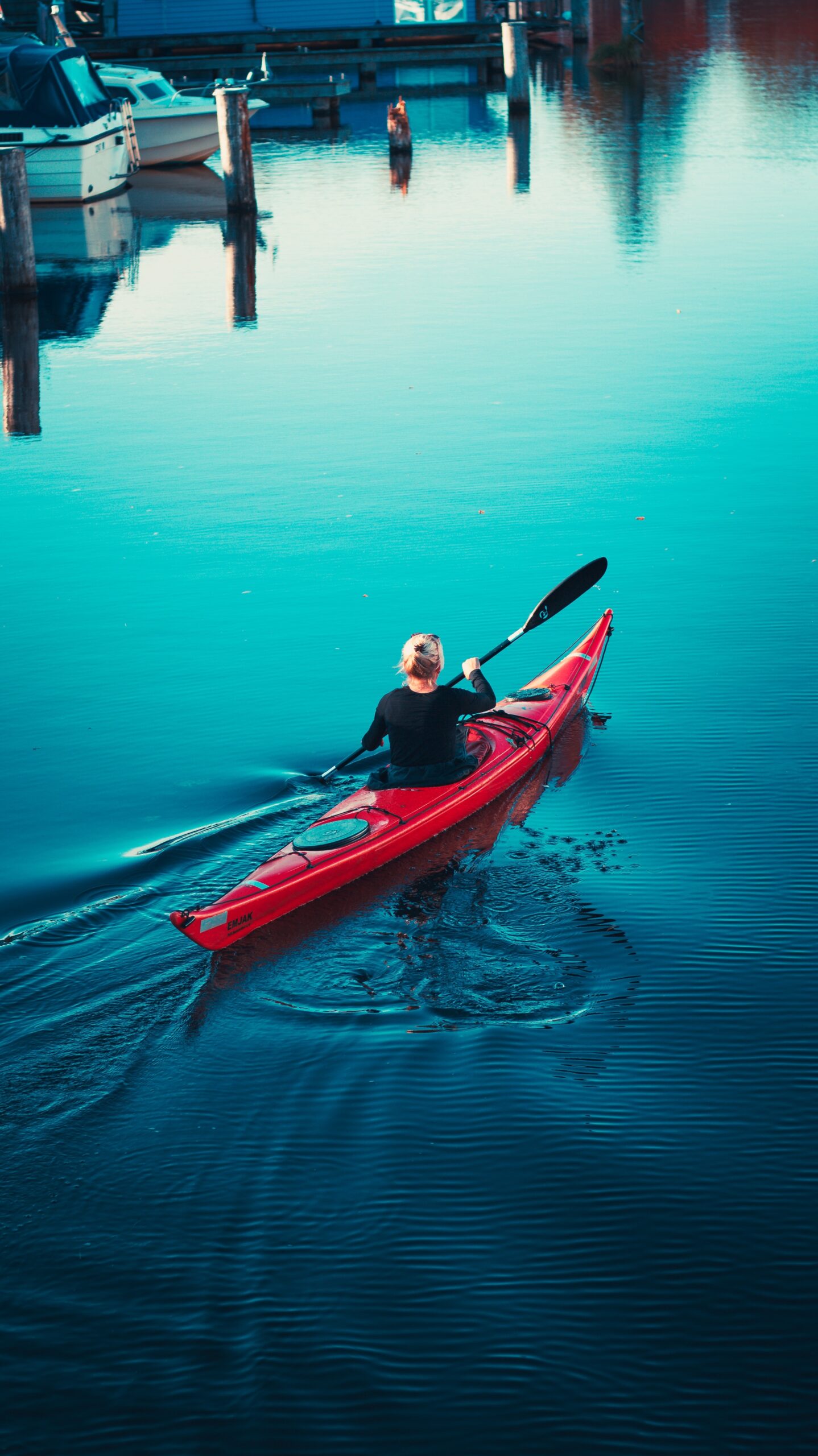 a man in a red kayak in the water