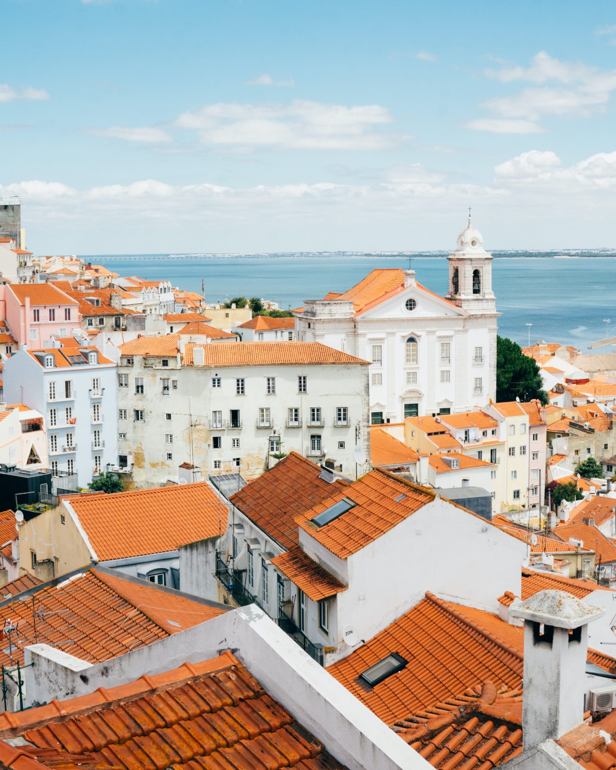 landscape photography of orange roof houses near body of water